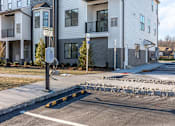 Thumbnail 37 of 63 - A street view of a residential area with apartment buildings and a parking meter.