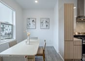 Thumbnail 9 of 63 - A dining room with a table and chairs.