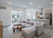 Thumbnail 2 of 63 - A modern living room with a grey sofa set and a wooden coffee table.