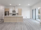 Thumbnail 32 of 63 - A modern kitchen with a stainless steel refrigerator and a wooden island.