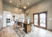 Thumbnail 19 of 22 - a kitchen with a large island with stools in front of it