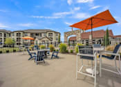 Thumbnail 18 of 22 - our patio has tables and chairs and umbrellas and is near our building