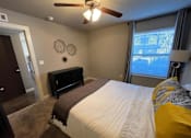 Thumbnail 10 of 22 - a bedroom with a bed and a ceiling fan