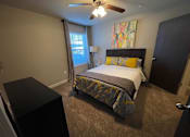 Thumbnail 9 of 22 - a bedroom with a bed and a ceiling fan