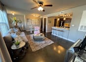 Thumbnail 1 of 22 - a living room and kitchen with a ceiling fan