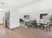 Thumbnail 4 of 12 - a living room with a kitchen and a table and chairs