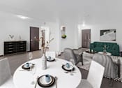 Thumbnail 5 of 12 - a living room and dining room with a white table and chairs