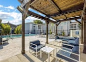 Thumbnail 10 of 12 - a covered patio with chairs and tables next to a pool