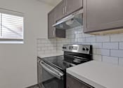 Thumbnail 2 of 12 - a kitchen with a stove and a window