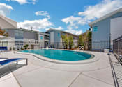 Thumbnail 8 of 12 - our apartments offer a swimming pool and a patio with chairs