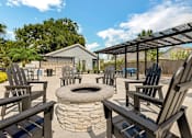 Thumbnail 7 of 11 - the fire pit is surrounded by wooden chairs and a pergola