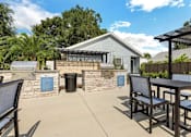 Thumbnail 5 of 11 - a patio with a table and chairs and a barbecue grill