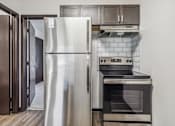 Thumbnail 1 of 11 - a kitchen with stainless steel appliances and a refrigerator