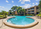 Thumbnail 2 of 7 - a swimming pool with a hotel in the background