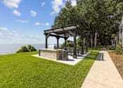 Thumbnail 13 of 19 - a picnic area with a grill and a view of the water