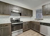 Thumbnail 1 of 19 - a kitchen with stainless steel appliances and wooden cabinets