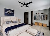 Thumbnail 5 of 19 - a bedroom with a bed and a ceiling fan