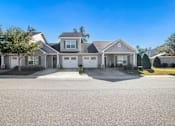 Thumbnail 13 of 14 - a house with a driveway and a street in front of it