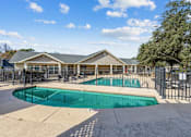 Thumbnail 11 of 14 - a swimming pool with a fence and a house behind it