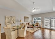 Thumbnail 4 of 14 - a living room with furniture and a ceiling fan