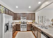 Thumbnail 2 of 14 - a kitchen with stainless steel appliances and wooden cabinets
