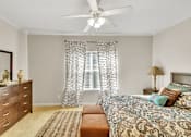 Thumbnail 8 of 14 - a bedroom with a bed and a ceiling fan