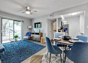 Thumbnail 6 of 13 - a living room and dining room with a sliding glass door