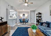 Thumbnail 4 of 13 - a living room and dining room with a ceiling fan