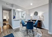 Thumbnail 5 of 13 - a dining room with a table and chairs and a kitchen