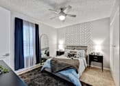 Thumbnail 8 of 13 - a bedroom with a bed and a ceiling fan