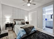 Thumbnail 9 of 13 - a bedroom with a large bed and a ceiling fan