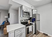 Thumbnail 3 of 13 - a kitchen with stainless steel appliances and a refrigerator
