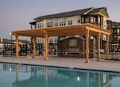 Thumbnail 3 of 35 - a building with a pool in front of it
