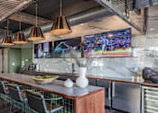 Thumbnail 9 of 35 - a restaurant with a long bar and a counter with chairs