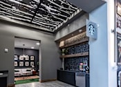 Thumbnail 17 of 35 - a lobby with a bar and a clock on the wall