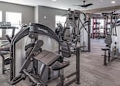 Thumbnail 19 of 35 - a gym with weights and other exercise equipment in a building