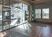 Thumbnail 22 of 35 - the lobby of a yoga studio with a yoga mat in front of a glass window