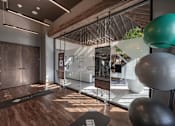 Thumbnail 23 of 35 - a gym with a glass door and a yoga ball on the floor