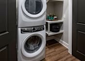 Thumbnail 33 of 35 - a small laundry room with a washer and dryer