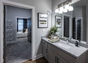 Thumbnail 34 of 35 - a bathroom with a sink and a mirror