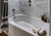 Thumbnail 35 of 35 - a white bathroom with a tub and a shower curtain