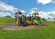 Thumbnail 18 of 18 - a playground with a slide and other toys in a park at The Lorient Apartments, Florida, 32514