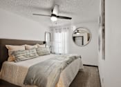 Thumbnail 11 of 18 - a bedroom with a bed and a ceiling fan at The Lorient Apartments, Pensacola, Florida