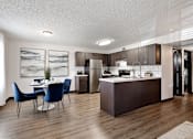 Thumbnail 3 of 18 - a kitchen and dining room with a table and chairs at The Lorient Apartments, Pensacola, FL, 32514