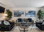 Thumbnail 8 of 18 - a living room with couches and a table at The Lorient Apartments, Pensacola, FL