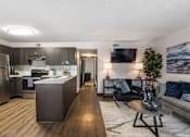 Thumbnail 5 of 18 - a living room and kitchen with a couch and a table at The Lorient Apartments, Pensacola, FL