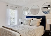 Thumbnail 10 of 18 - a bedroom with a bed and two mirrors above it at The Lorient Apartments, Florida