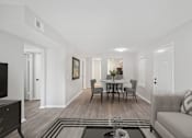 Thumbnail 5 of 16 - a living room and dining room with white walls and wood floors