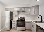 Thumbnail 2 of 16 - a kitchen with stainless steel appliances and white cabinets