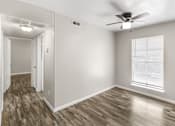 Thumbnail 4 of 9 - A room with a ceiling fan and a window with blinds.